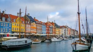 Scenic view of Nyhavn Canal with colorful buildings and moored boats in Copenhagen.